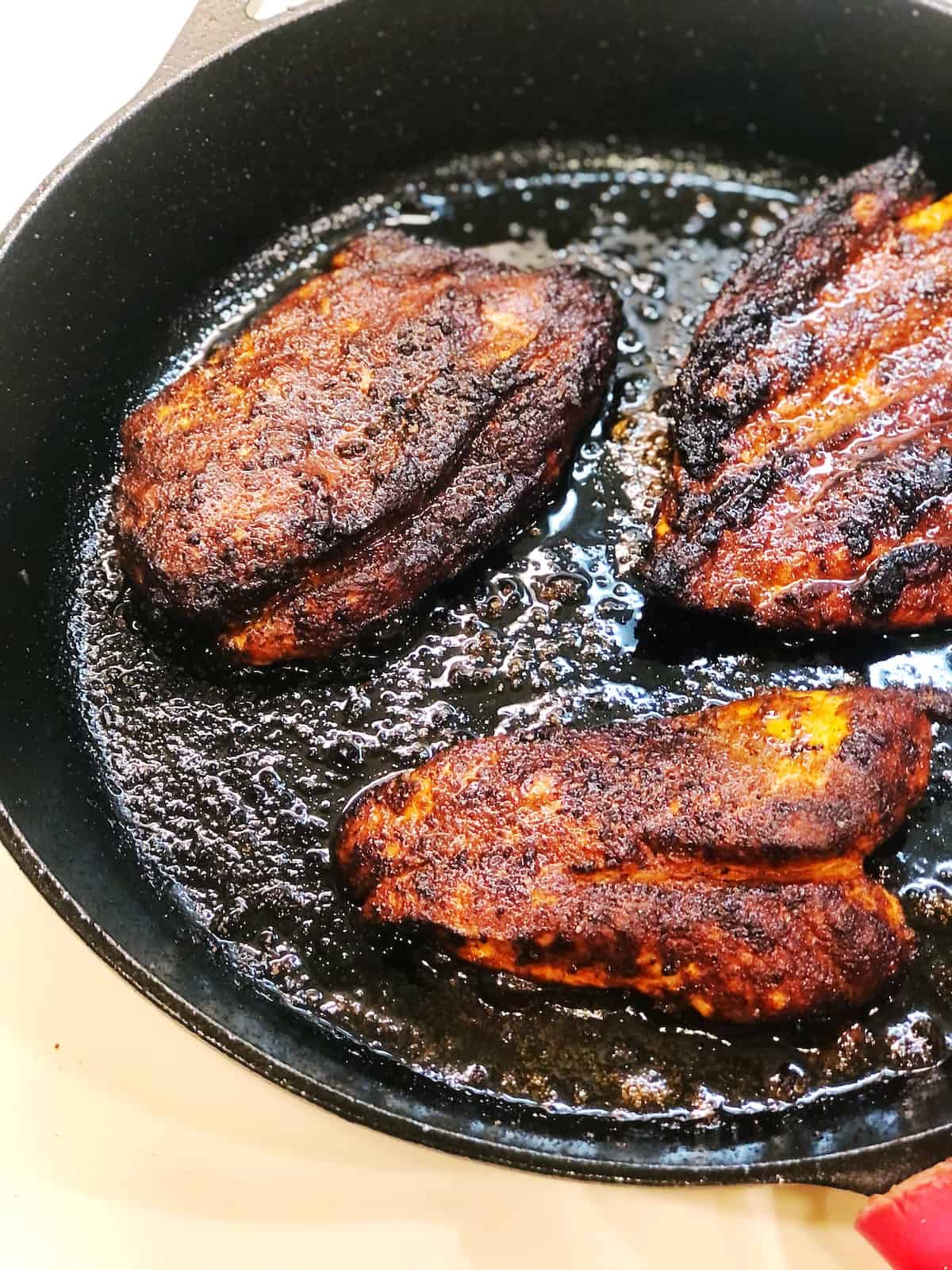 blackened chicken in cast iron pan