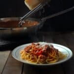 bolognese in a bowl on a wood table