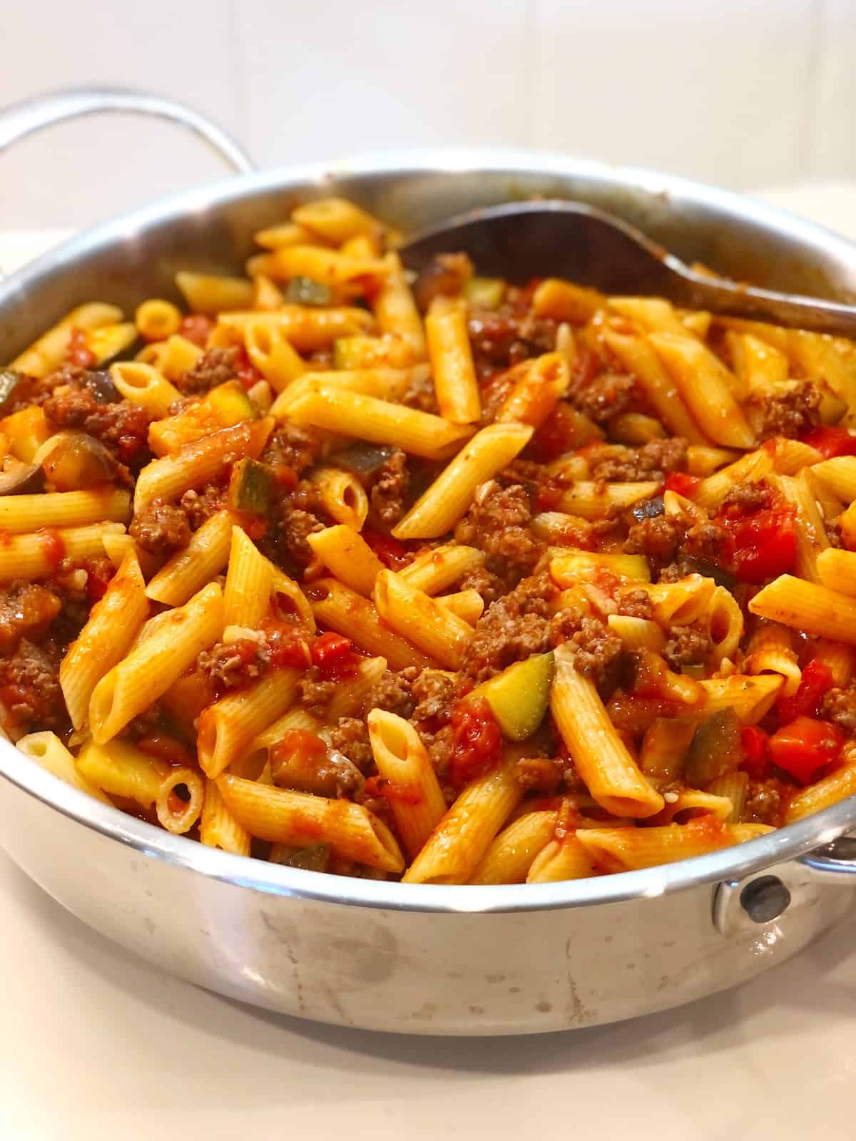 veggie meat sauce tossed with pasta in pan