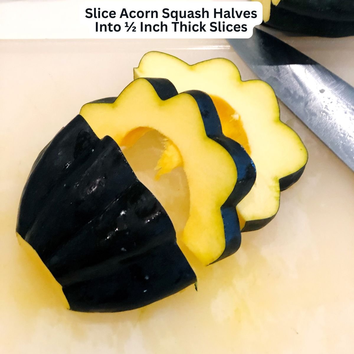 Cutting acorn squash into slices for roasting.