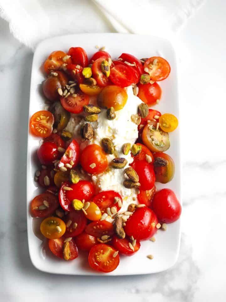 Tomato and ricotta salad on a plate.