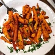 Harissa roasted carrots on a plate.