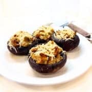 Stuffed portobello mushrooms with stuffing on a plate.