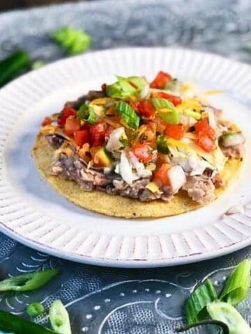 Refried bean tostadas on a plate.