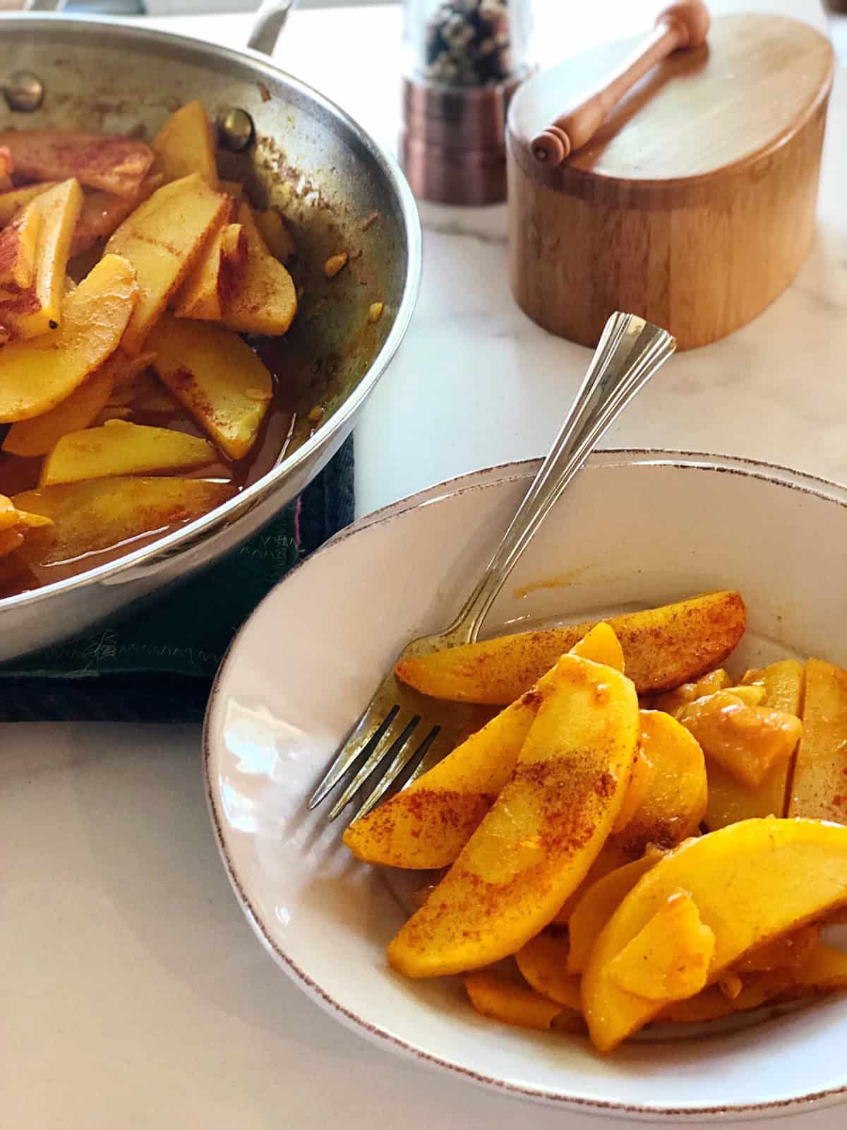 Golden potatoes with turmeric in a small bowl.