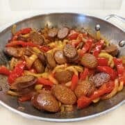 Chorizo and peppers cooked in a pan.