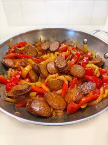 Chorizo and peppers cooked in a pan.