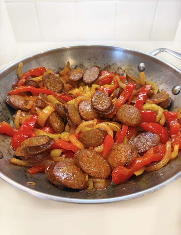 Chorizo and peppers cooked in a pan.