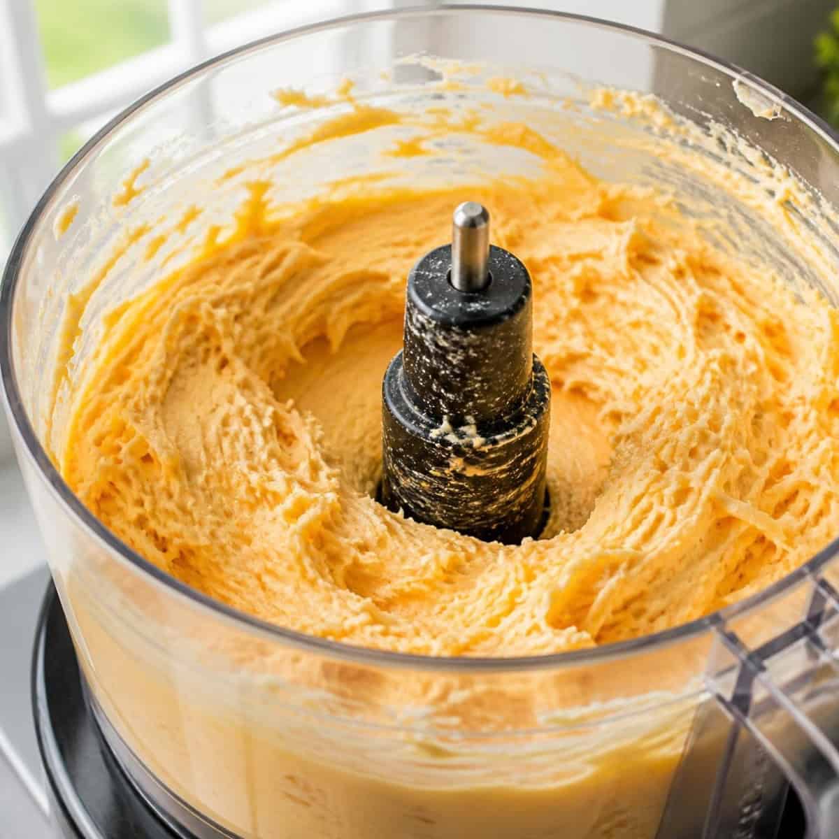 Mixing the beer cheese dip in the food processor.