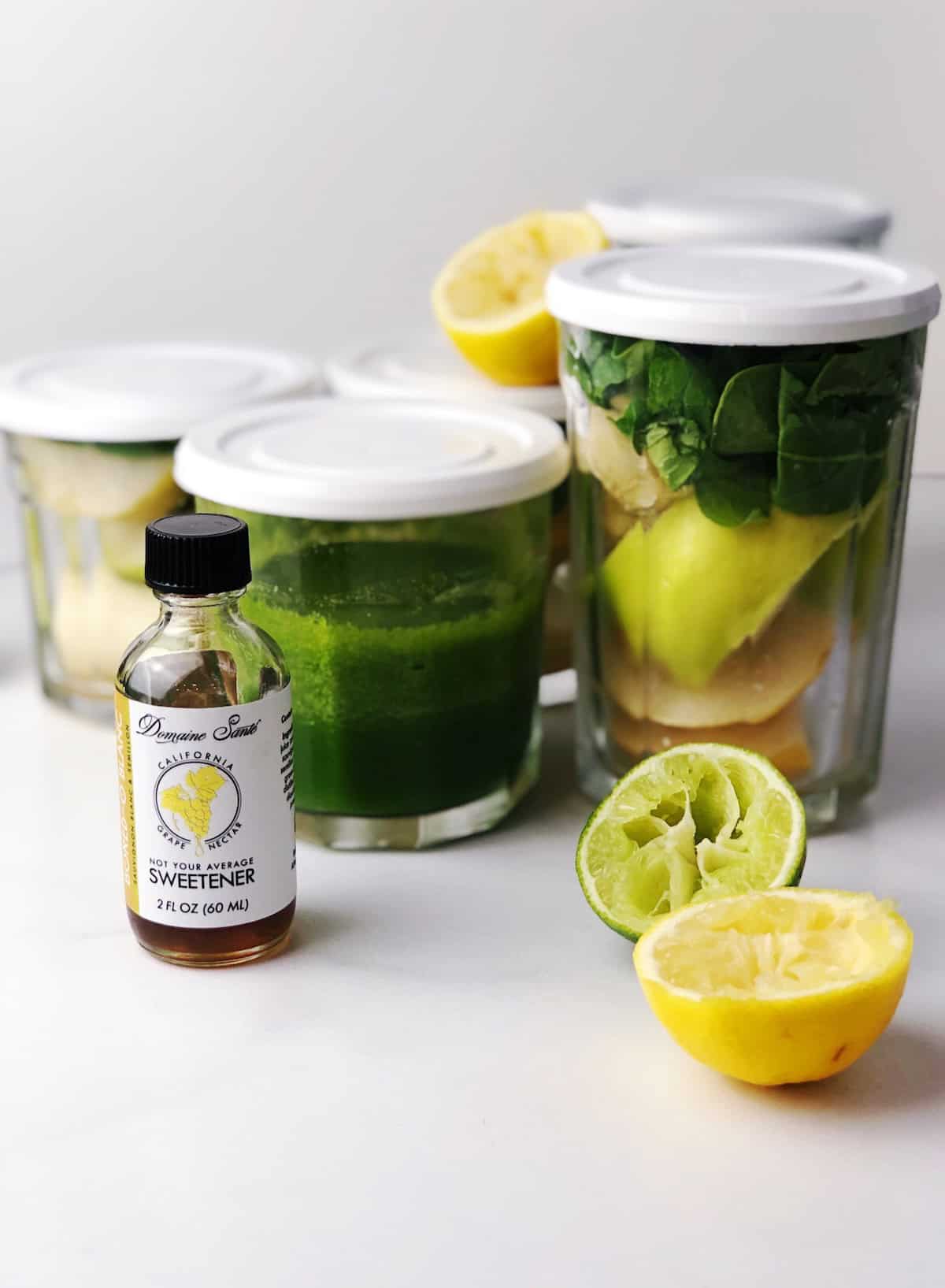 Green juice ingredients in working jars with lids.