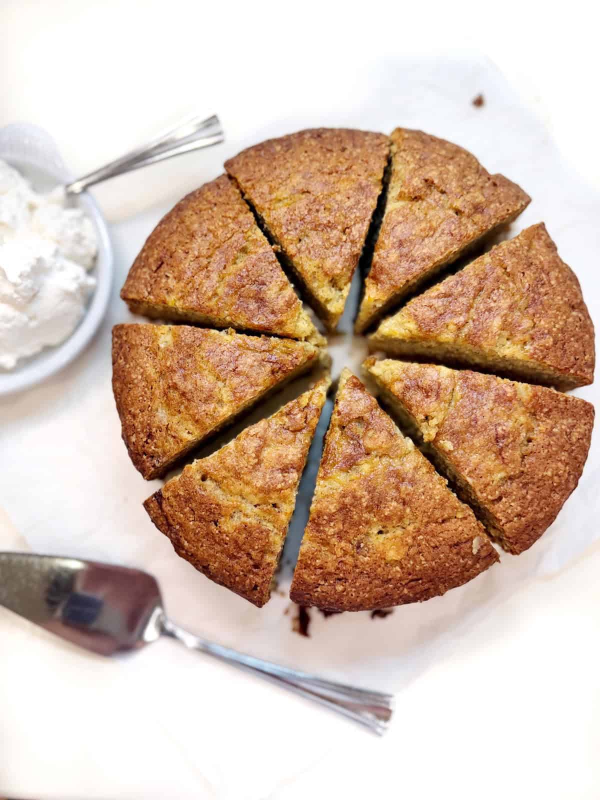 Banana bread with a spatula and whipped topping.